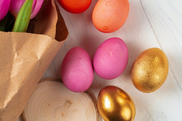 Pink tulips and  colorful eggs. Easter concept