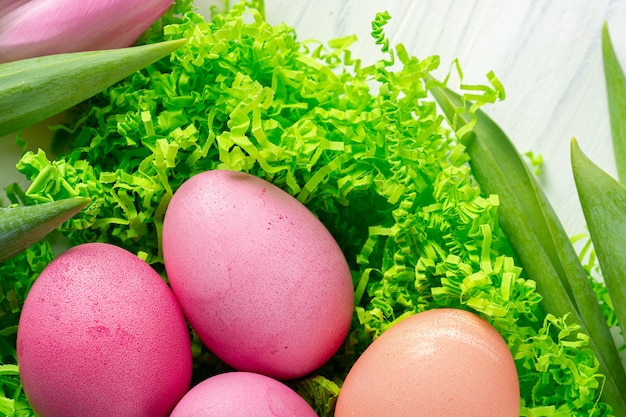 Pink tulips and colorful eggs