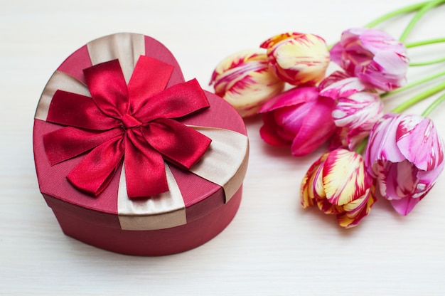 Pink tulips and heart box shape isolated on white