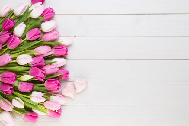 Pink tulips on white wooden table