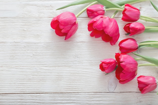 Pink tulips on white wooden table