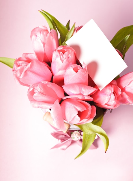 Pink tulips with card closeup