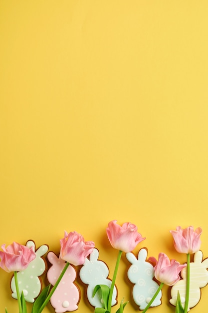 Pink tulips with easter gingerbread eggs located in a row