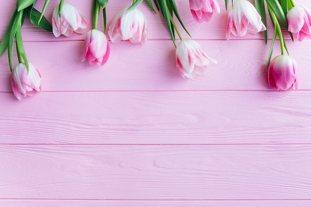 Pink tulips on a wooden background.Top view and flat lay.