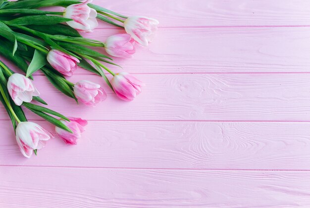 Pink tulips on a wooden background.Top view and flat lay.