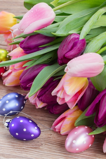 Pink and violet tulip flowers with easter eggs