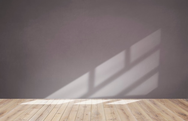 Pink wall in an empty room with a wooden floor