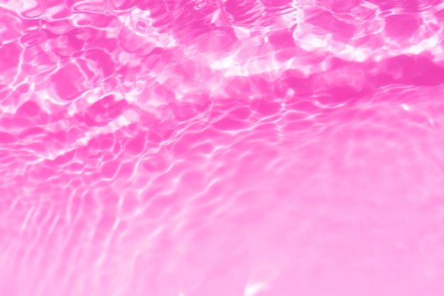 Pink water with ripples on the surface Defocus blurred transparent purple colored clear calm water