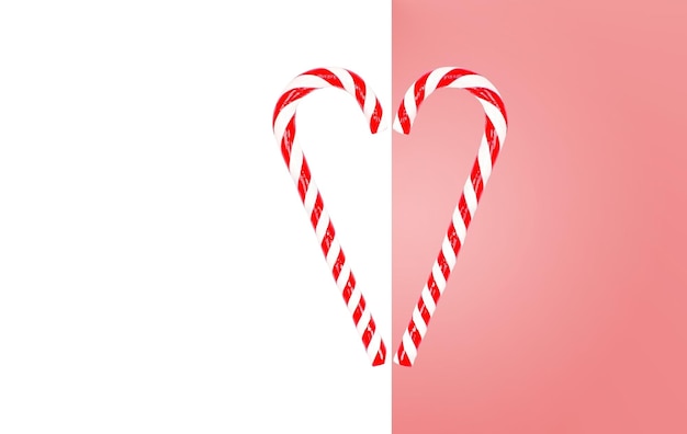 Pink and white background with Christmas lollipops folded in the shape of a heart