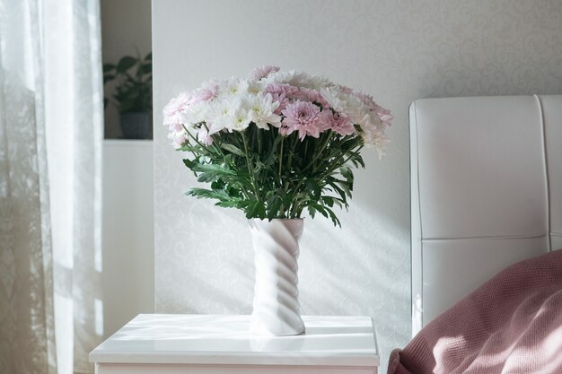 pink and white chrysanthemum flower in vase light and airy minimalism concept