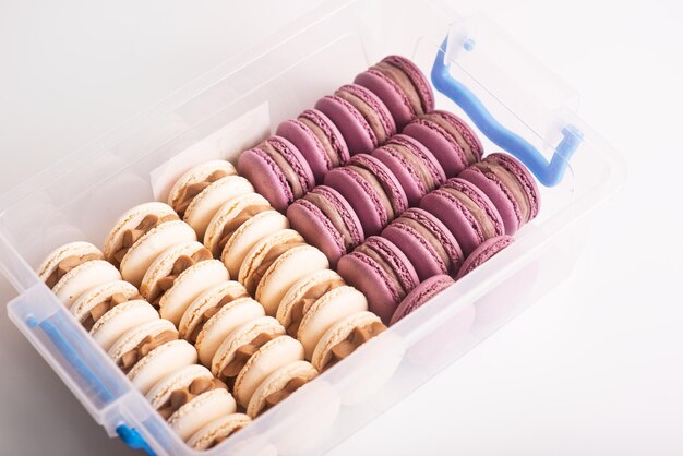 Pink and white macarons cookies in the box Isolated on white background Tasty dessert