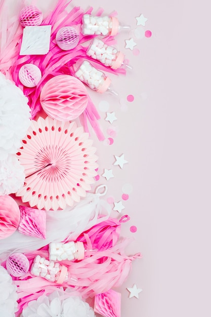 Pink and white Paper Decorations for Baby shower party. It's a Girl. Flat lay, top view