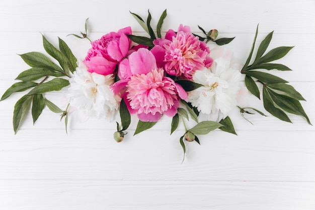 Pink and white peonies on a white wooden background copy space flat lay greeting card