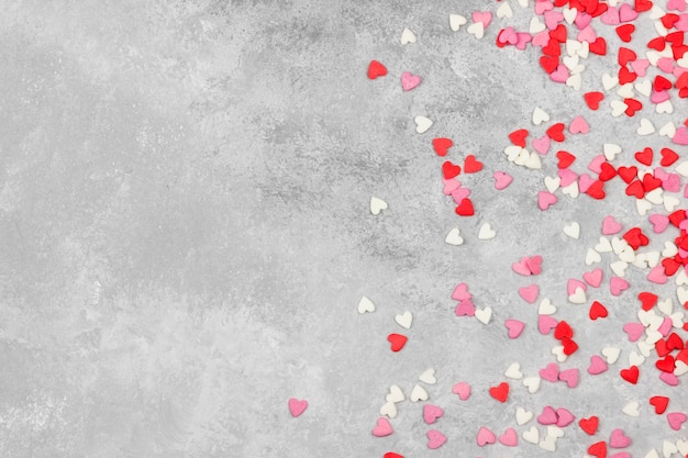 Pink, white and red hearts on a light background. Top view, copy space.