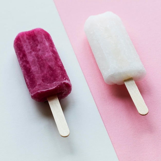 Pink and white summer ice lollies on a pink background
