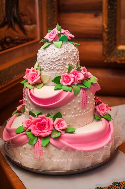 Pink and white wedding cake on a dessert table