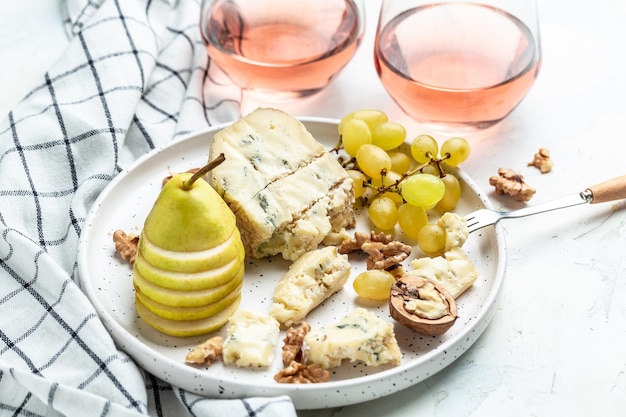 Pink wine rose aged cheese camembert cheese nuts honey grapes\
pears blue cheese glasses of wine french cuisine delicious food\
wine snacks assorted