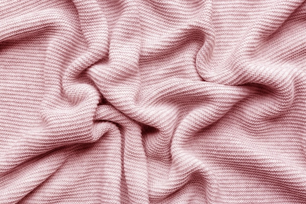 Pink woolen knitted fabric as background