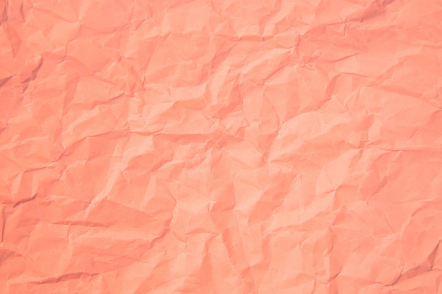 ピンクのしわは、紙のページのテクスチャの粗い背景で古いしわくちゃになりました。しわグランジ羊皮紙パターンヴィンテージ