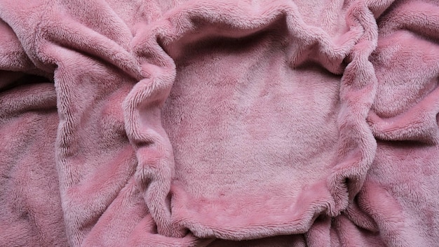 Photo pink wrinkled furry pajama jumper textured background with circle with copy space