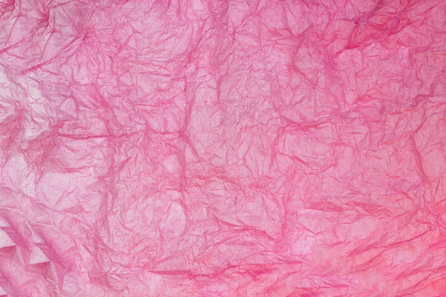 Pink wrinkled paper texture background. 