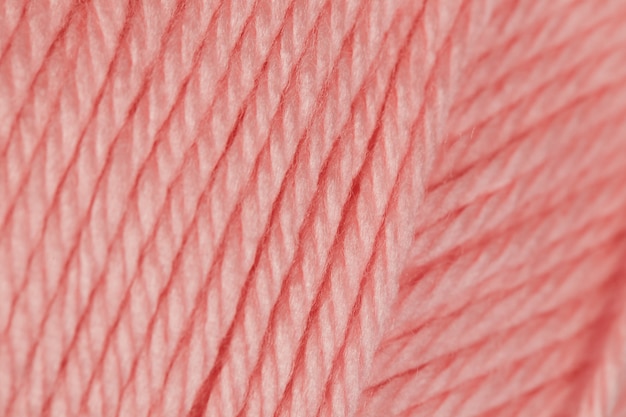 写真 かぎ針編みのピンクの糸は、テクスチャの背景を閉じます。