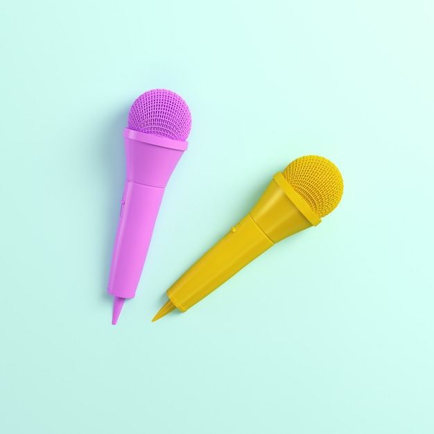 Pink and yellow microphones on bright background