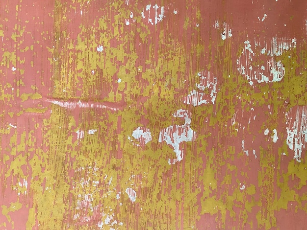 A pink and yellow wall with white spots and a green stripe.