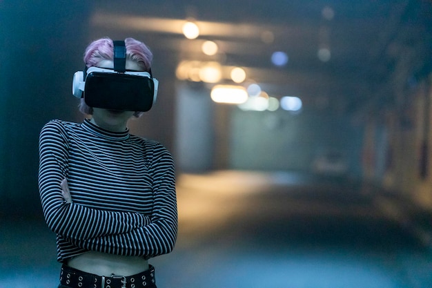 ピンクの髪の少女が腕を組んでVRセットを着用