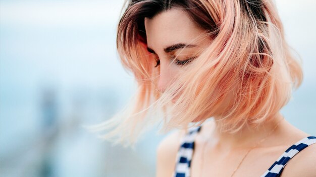 Pinkhaired girl on the pier