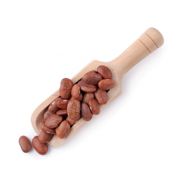 Pinto beans in a wooden bowl isolated on a white background