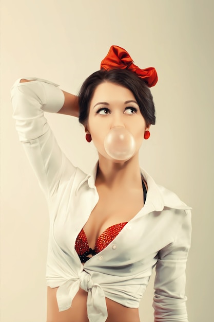 Pinup woman with bubble gum in studio