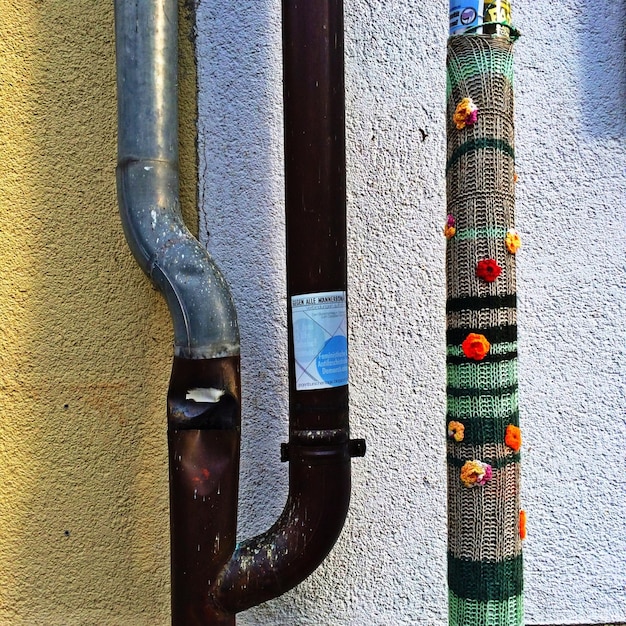 Photo pipe covered with mat and artificial flowers