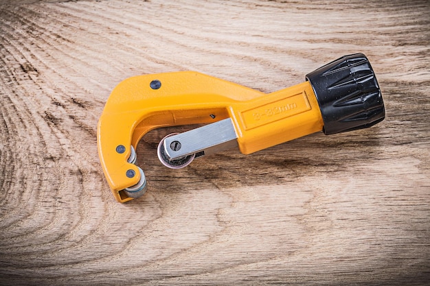 Pipe cutter on wooden board plumbing concept