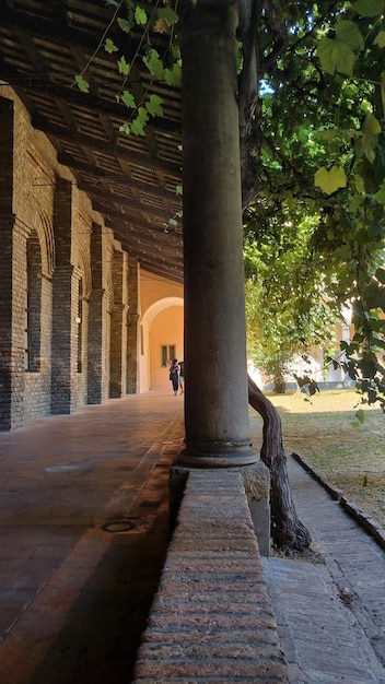 A pipe is visible on a wall in a courtyard.