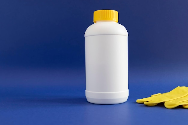 pipe plumber drain granules in white plastic bottle with yellow cap rubber glove on blue purple