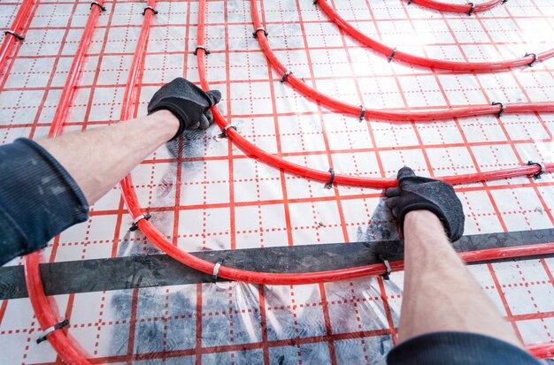 Pipefitter install system of underfloor heating system at home