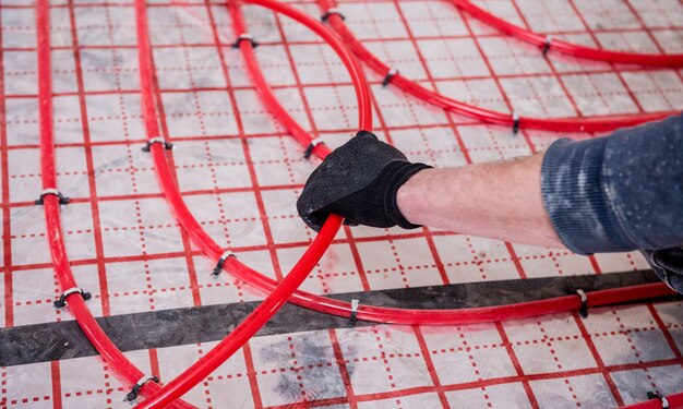 Pipefitter install system of underfloor heating system at home