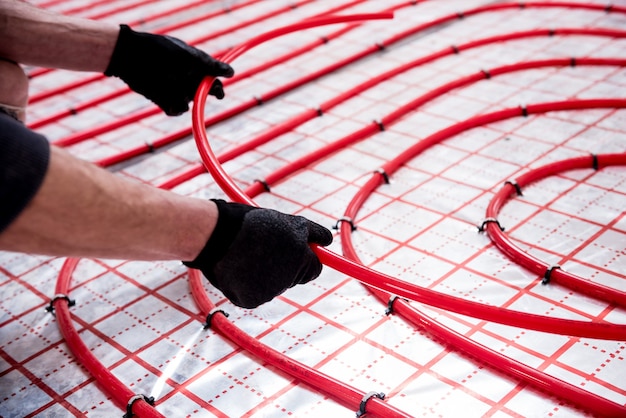 Pipefitter install system of underfloor heating system at home