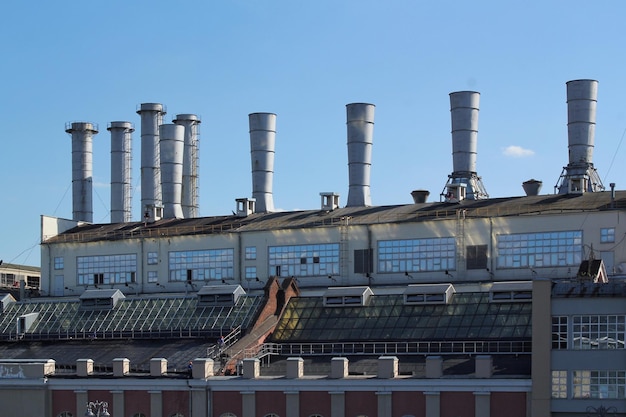 Pipes of thermal power plant on a town. industrial zone in the
city. producing electrical energy con