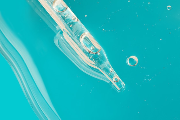 Pipette from dropper in the cosmetics gelTop viewliquid cosmeticmacro photography