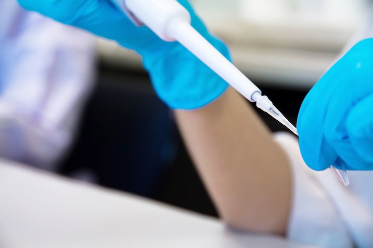 Photo pipette with drop of liquid in a science research lab