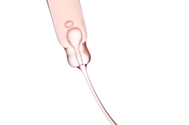 Photo pipette with a viscous pink cosmetic closeup