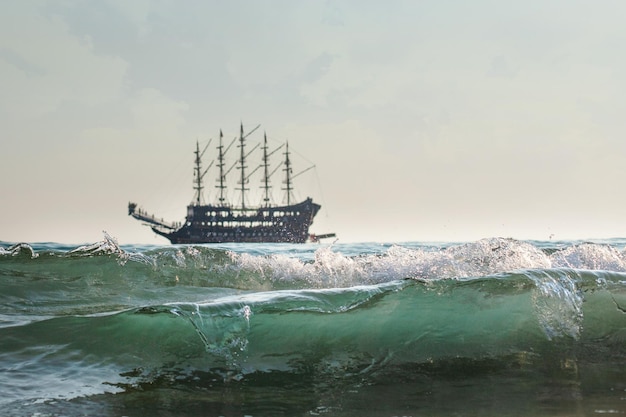 Pirate ship on the horizon, strong waves are ashore