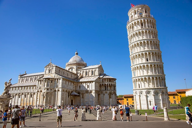 Pisa, Italy - August 29, 2012: Pisa Leaning tower and Cathedra, and tourists l in Italy in summertime