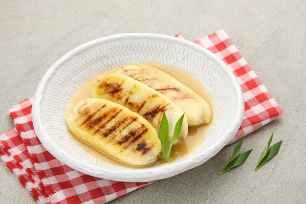 Pisang Gapit or Pisang Epe grilled banana with palm sugar sauce Indonesian traditional food