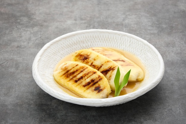 Pisang Gapit or Pisang Epe grilled banana with palm sugar sauce Indonesian traditional food