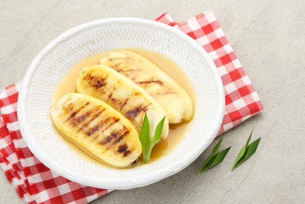 Pisang Gapit or Pisang Epe grilled banana with palm sugar sauce Indonesian traditional food