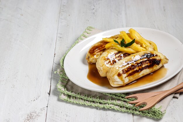 Pisang Gapit or pisang Epe is Grilled banana with coconut brown sugar sauce and jack fruit topping