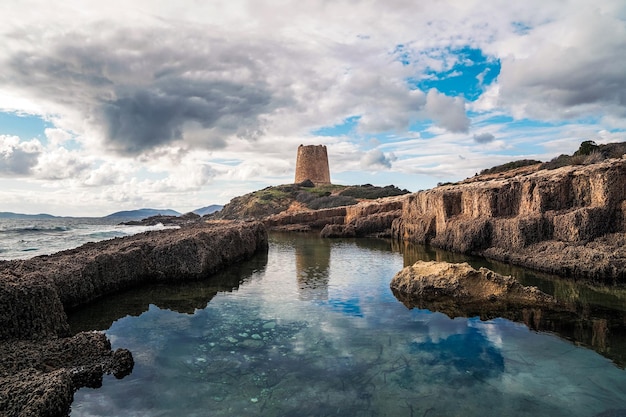 Photo the piscinni tower and the phoenicians rock cave near teulada